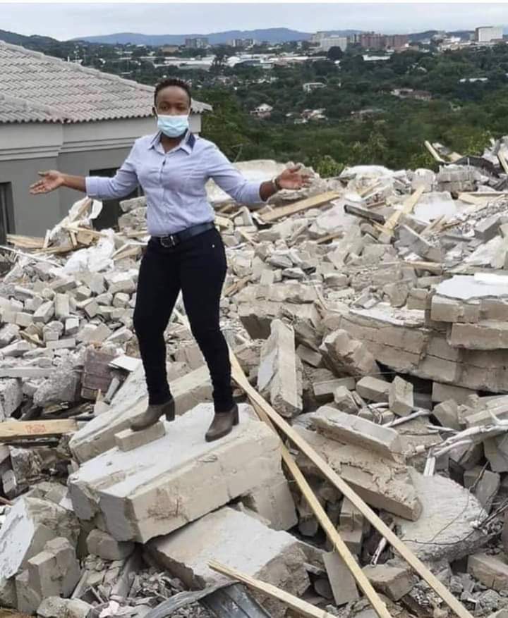 Lady poses on demolished house
